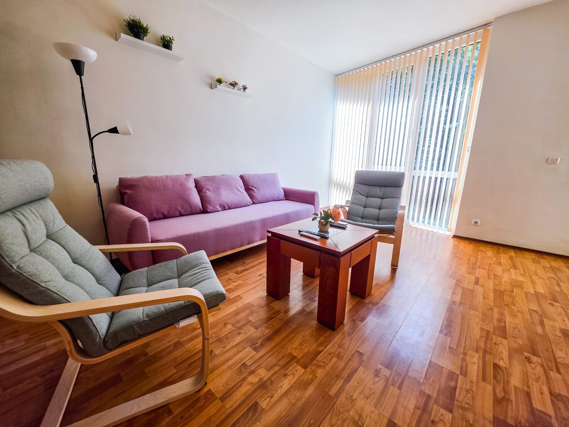Bright, airy living room with cozy seating and warm wood floors